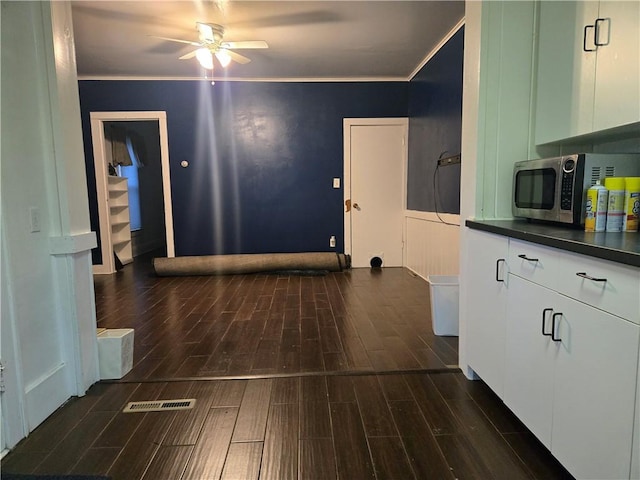 corridor featuring dark hardwood / wood-style flooring and ornamental molding