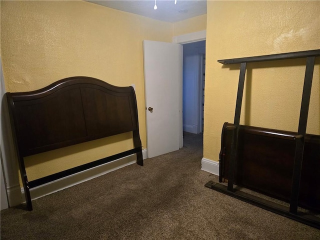 bedroom featuring dark colored carpet