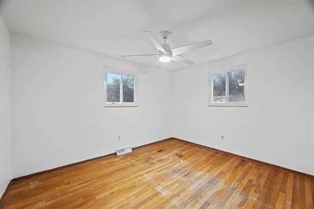 spare room with ceiling fan and light wood-type flooring