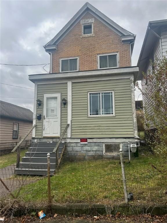 rear view of house with a lawn