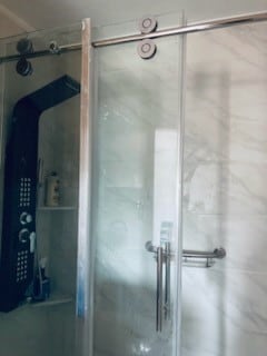 bathroom featuring a shower with door