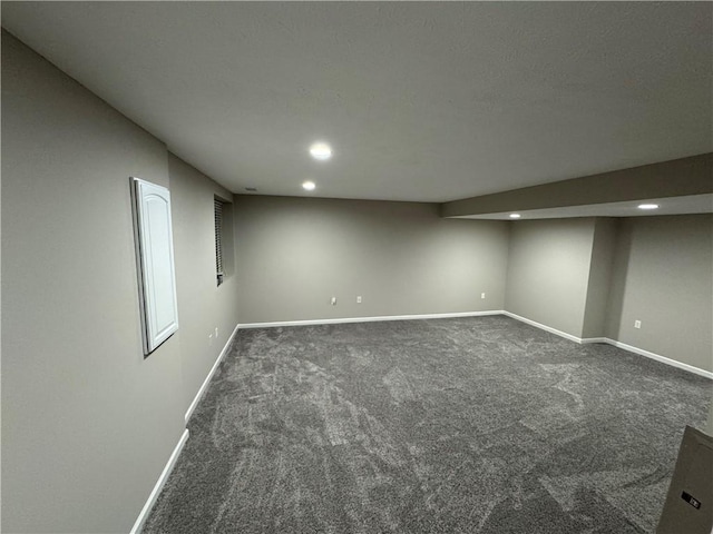 basement with dark colored carpet