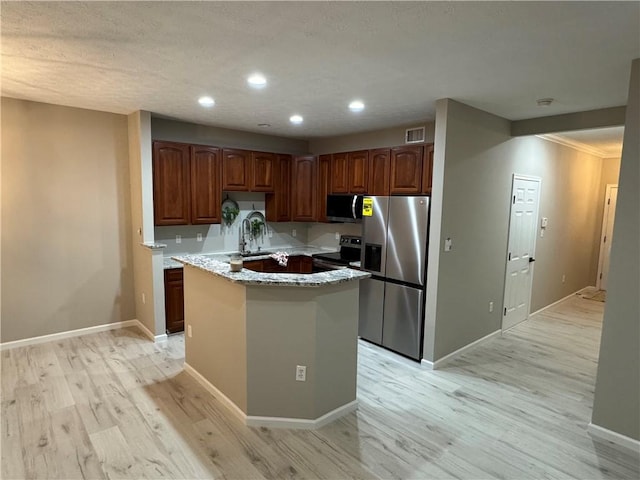 kitchen featuring sink, light wood-type flooring, and stainless steel appliances