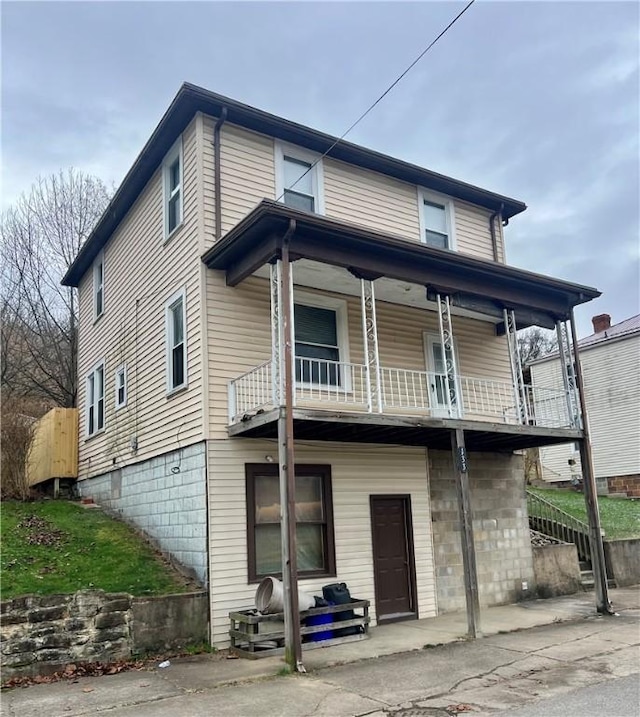 rear view of house featuring a balcony