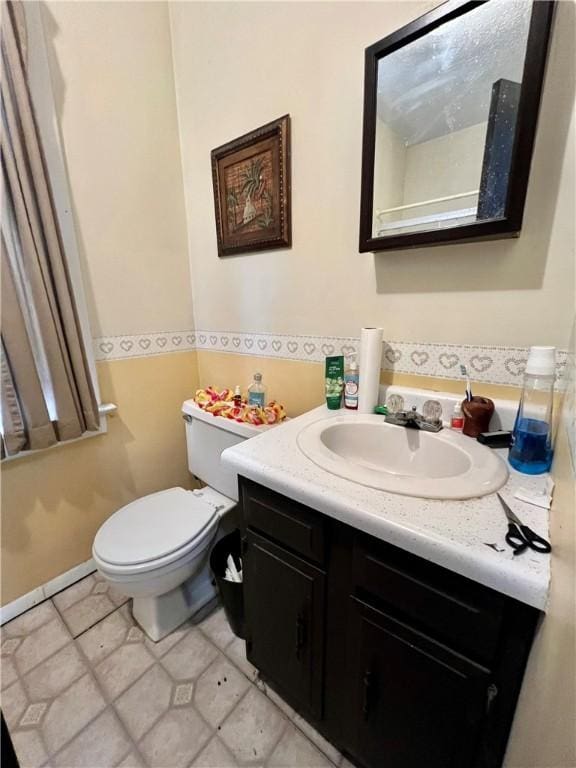 bathroom featuring tile patterned floors, vanity, and toilet