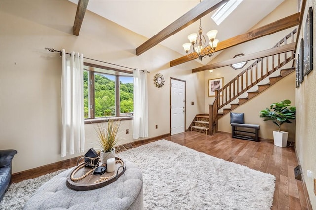 living room with lofted ceiling with beams, hardwood / wood-style flooring, and a notable chandelier