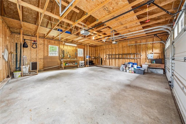 garage with a workshop area and a garage door opener