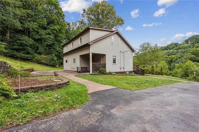 rear view of house featuring a lawn