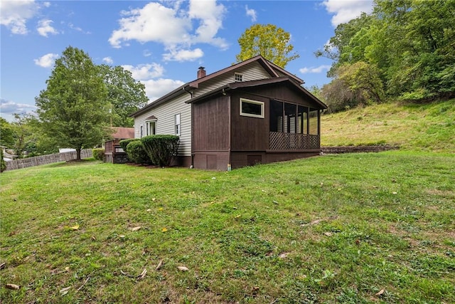 view of home's exterior with a yard