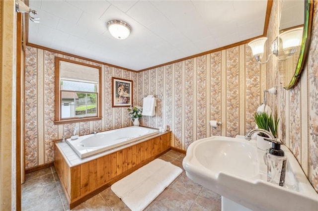 bathroom with a chandelier, a bathtub, and crown molding