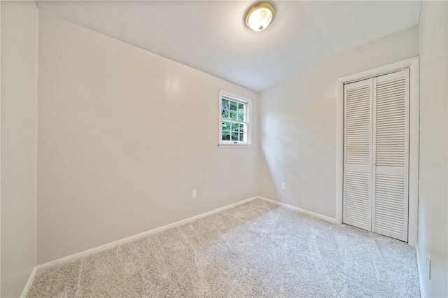 unfurnished bedroom with carpet flooring and a closet