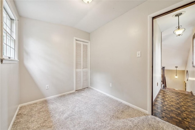 spare room featuring lofted ceiling and parquet floors