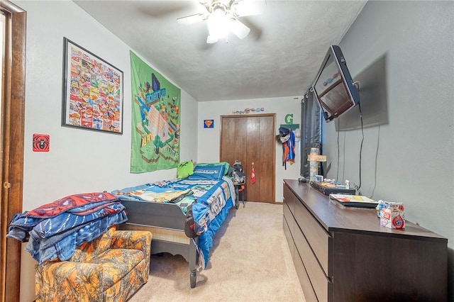 bedroom featuring light colored carpet and ceiling fan