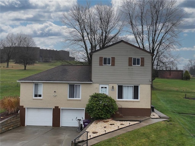 back of property with a lawn and a garage