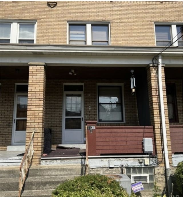 view of exterior entry featuring a porch