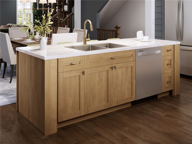 kitchen featuring light brown cabinets, sink, dark hardwood / wood-style floors, an island with sink, and appliances with stainless steel finishes