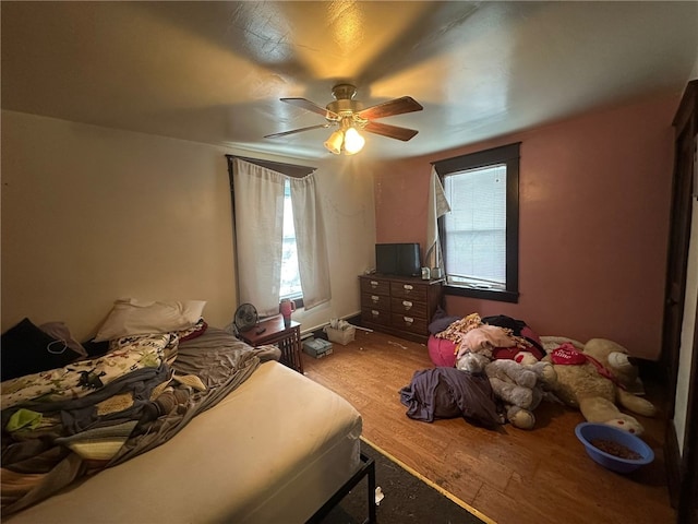 bedroom with ceiling fan and light wood-type flooring