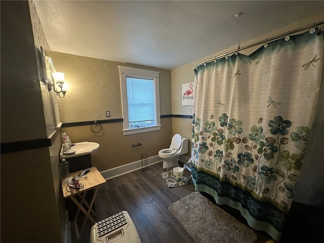 bathroom featuring shower / bath combo, toilet, and wood-type flooring