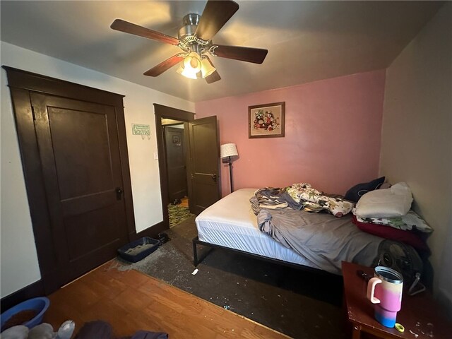 bedroom with ceiling fan and hardwood / wood-style floors