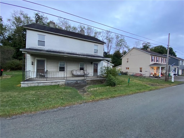 view of front facade with covered porch and a front yard