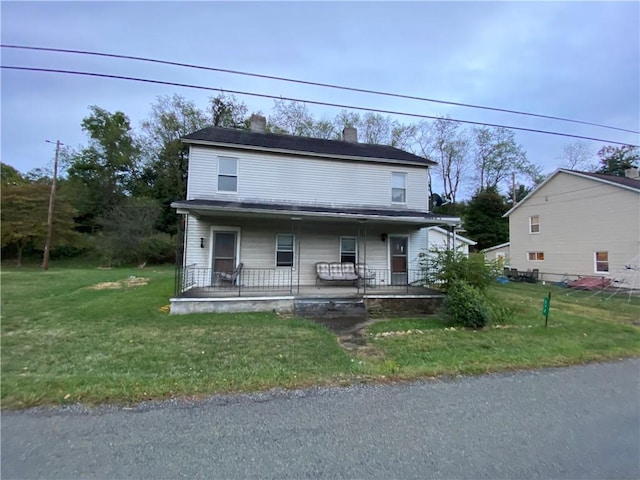 view of front of property featuring a porch and a front yard