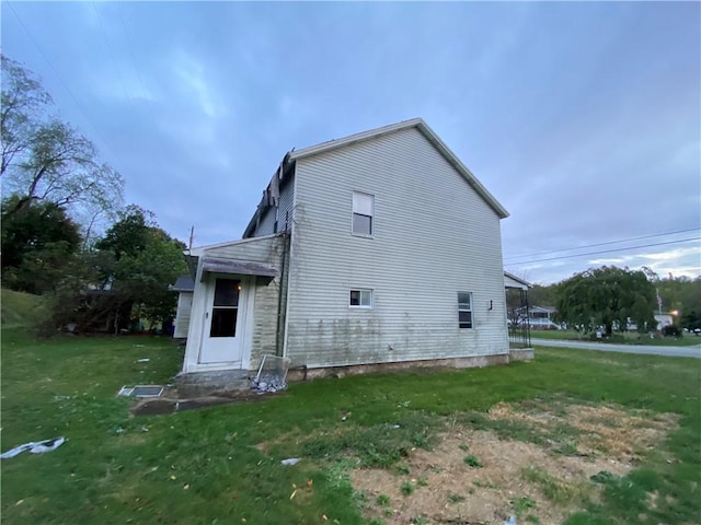 rear view of property with a lawn