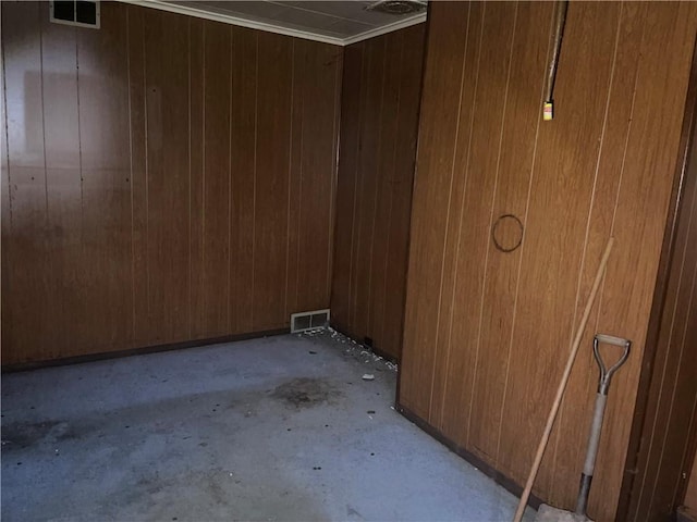 unfurnished room featuring wood walls