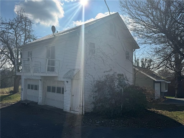 view of side of home featuring a garage