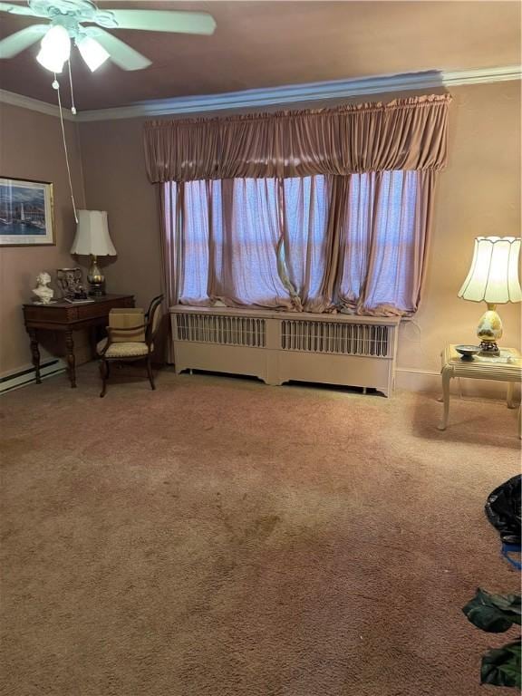 sitting room with a wealth of natural light, ornamental molding, carpet floors, and radiator