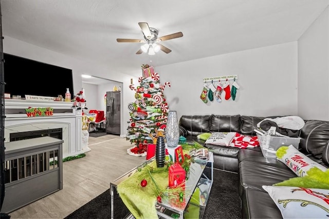 living room with ceiling fan and light hardwood / wood-style flooring