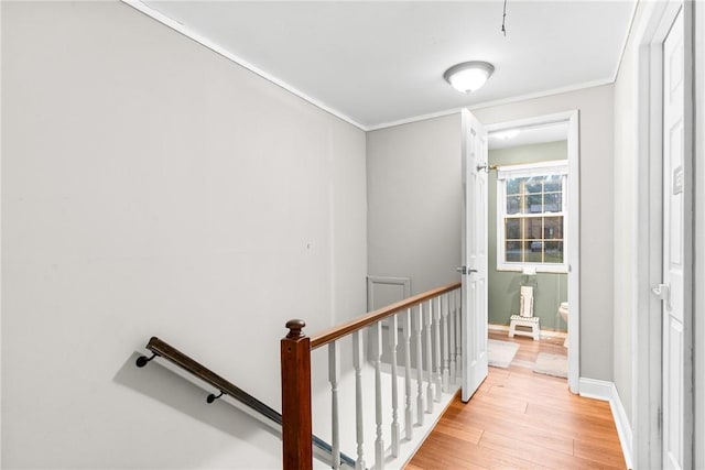 staircase with hardwood / wood-style flooring and ornamental molding