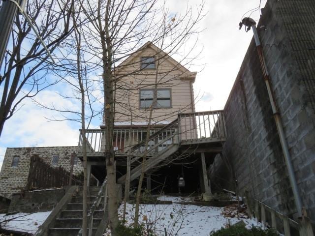 snow covered property featuring a wooden deck