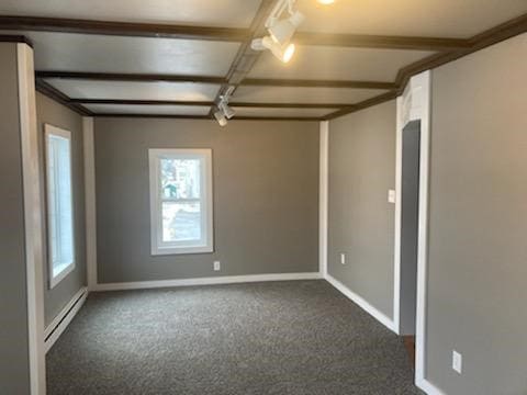 unfurnished room featuring coffered ceiling, a baseboard heating unit, beam ceiling, and dark colored carpet