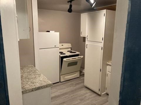 kitchen featuring light stone countertops, white appliances, white cabinetry, and light hardwood / wood-style flooring