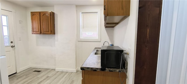 kitchen with light wood-type flooring and sink