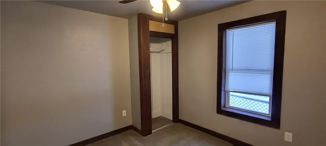 unfurnished bedroom with ceiling fan and carpet