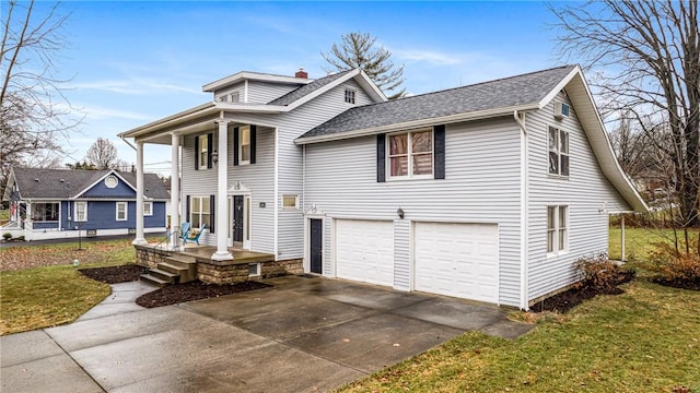 view of front of property featuring a garage and a front lawn