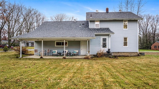 rear view of property with a patio area and a yard