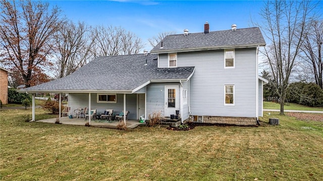 rear view of house with central AC unit, a patio area, and a yard