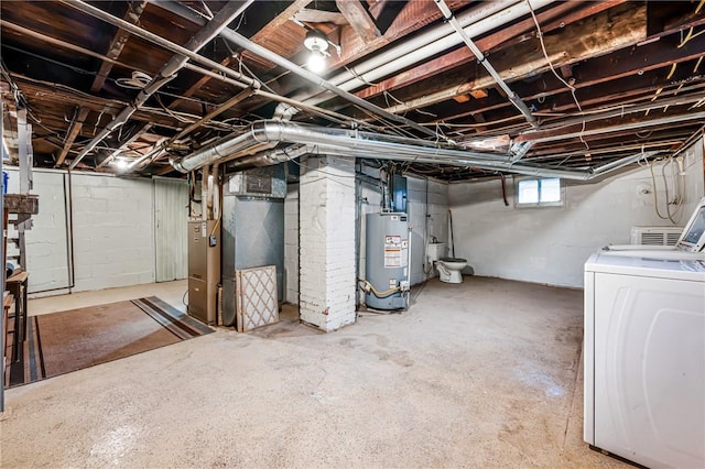 basement with gas water heater, washer / clothes dryer, and heating unit