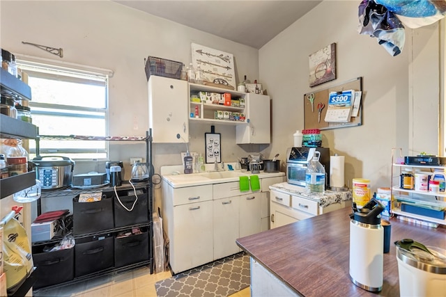 kitchen with white cabinetry and sink