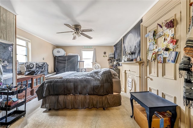 bedroom featuring ceiling fan, crown molding, and light carpet