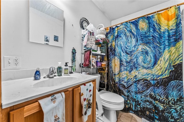 bathroom featuring vanity, tile patterned flooring, and toilet