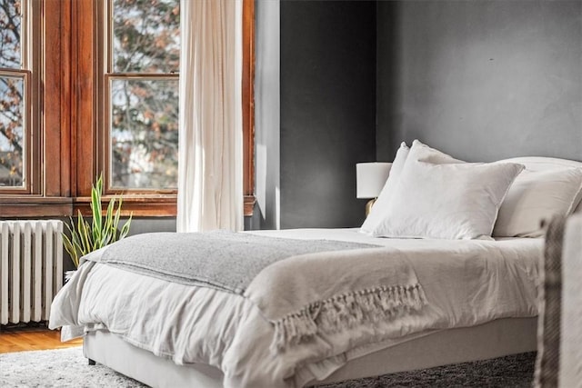 bedroom featuring hardwood / wood-style floors and radiator