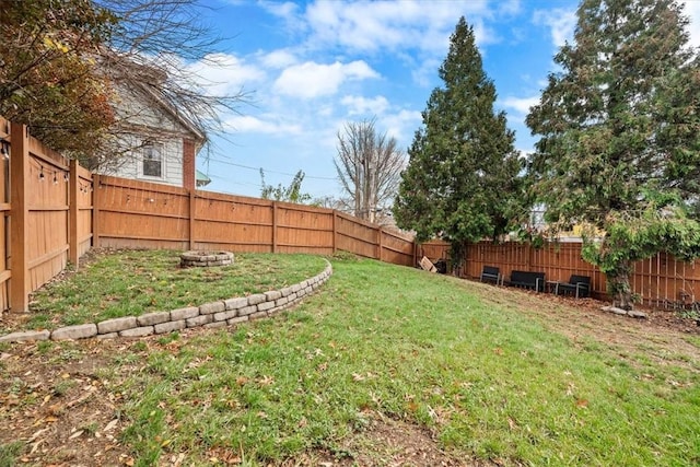 view of yard with an outdoor fire pit