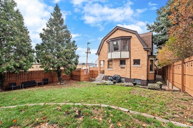 rear view of property featuring a yard