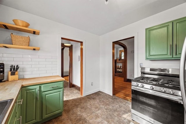 kitchen featuring butcher block countertops, tasteful backsplash, green cabinets, and stainless steel gas range