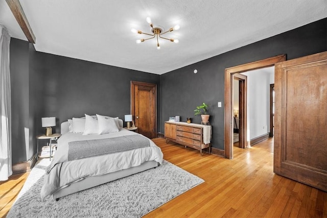 bedroom featuring a chandelier and wood-type flooring