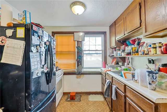 kitchen featuring black fridge and sink