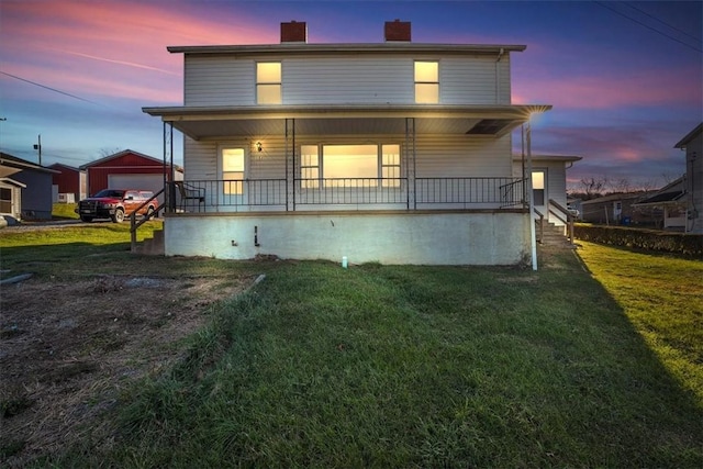 back house at dusk with an outdoor structure, a porch, a garage, and a yard